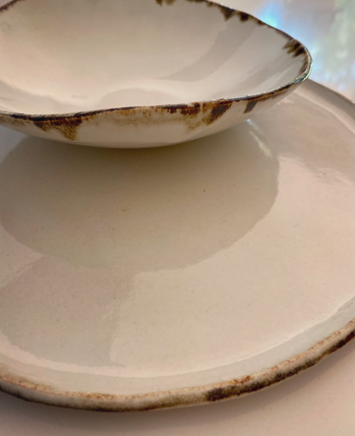 The Halo Collection | Detailed Image of Opal White with Brown Edging Dining Plates and Bowls | Tor Pottery