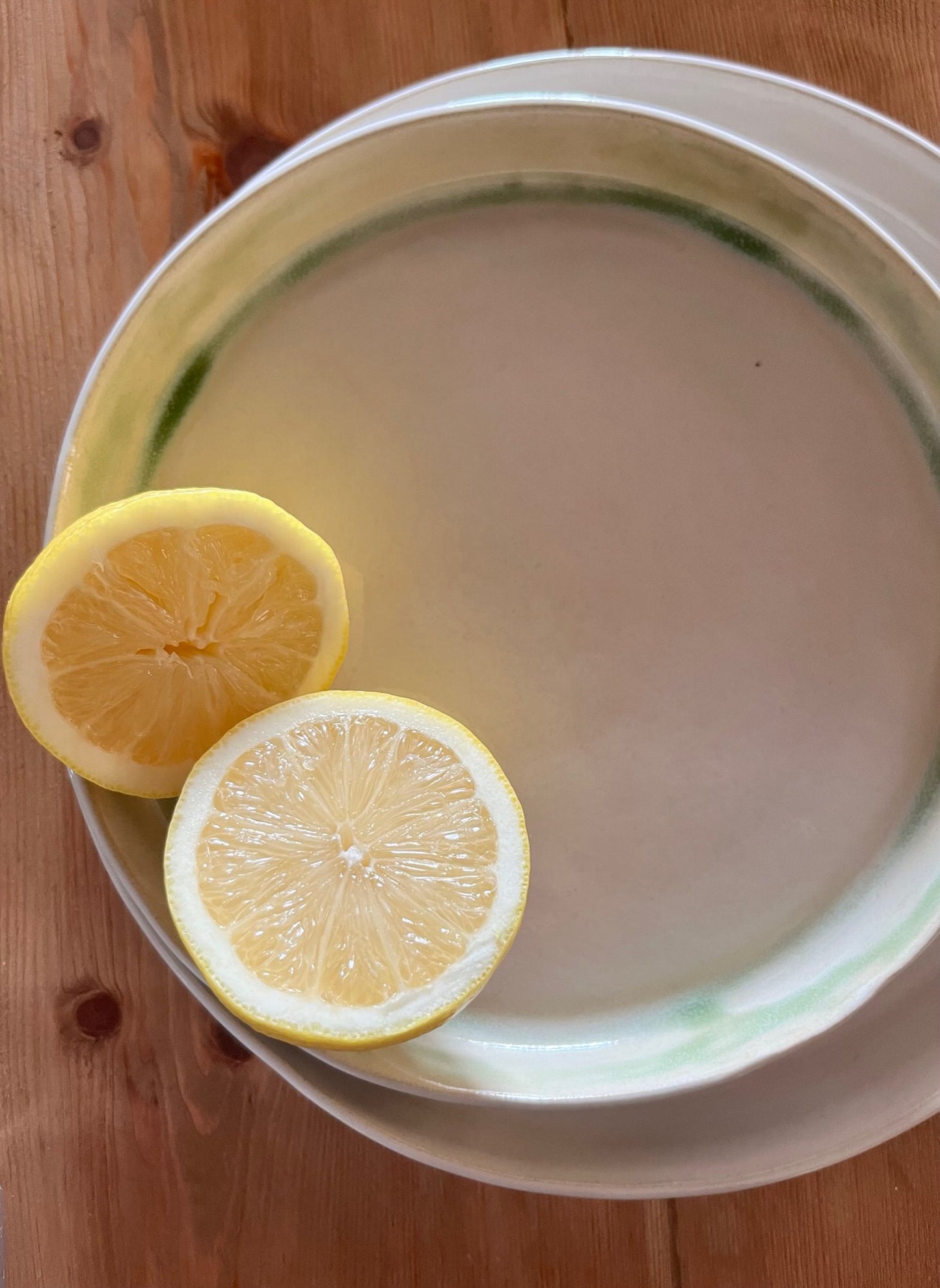The Farm Collection | Detailed image of Opal White Plates with Green Edging | Tor Pottery